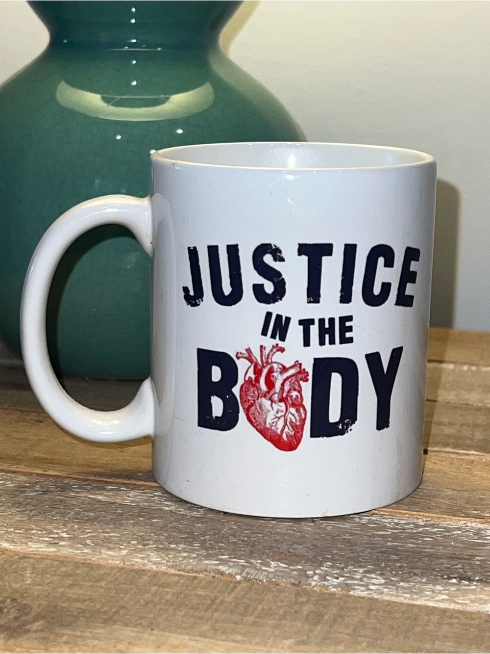 Justice in the Body White Coffee Mug with Red Heart Graphic